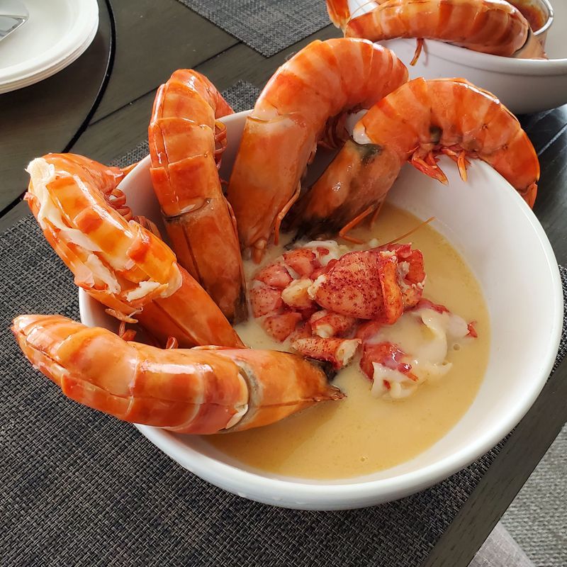 A bowl of giant shrimp in lobster bisque