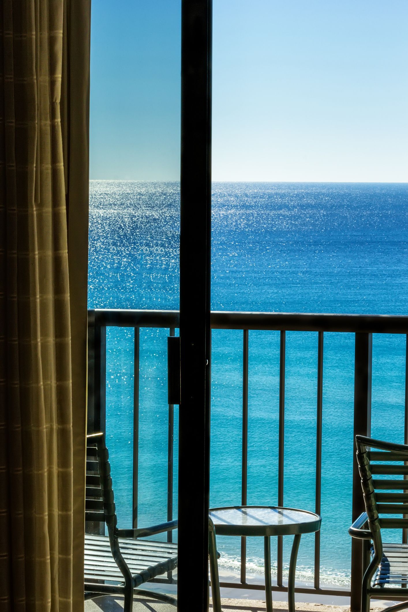 A View Of The Ocean Through A Sliding Glass Door - Flagler County, FL - Screen Windows Painting Services