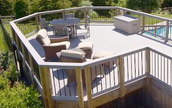 There is a large deck with a table and chairs on it.