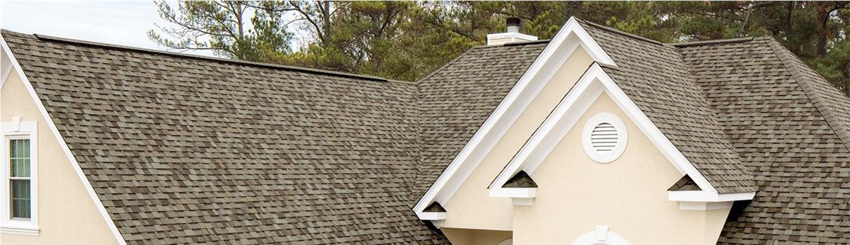 A close up of a house with a roof and a window.