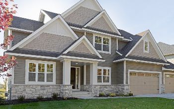 A large house with a lot of windows and a garage.