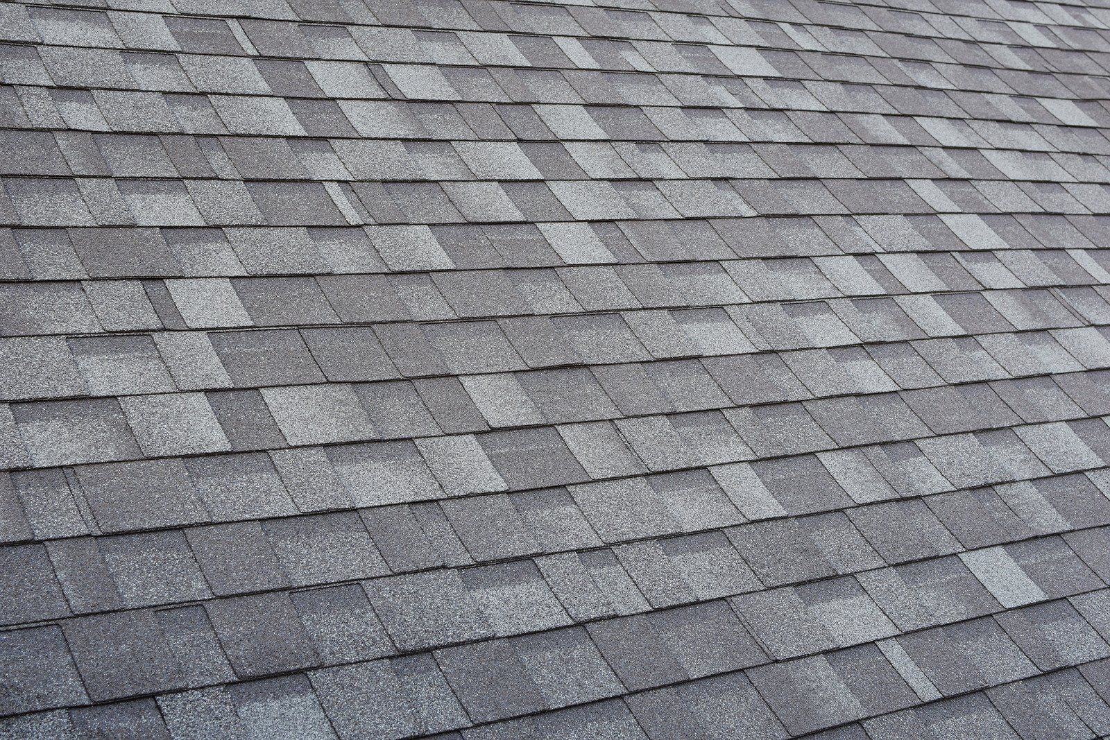 Gray asphalt shingle roof, close-up view.