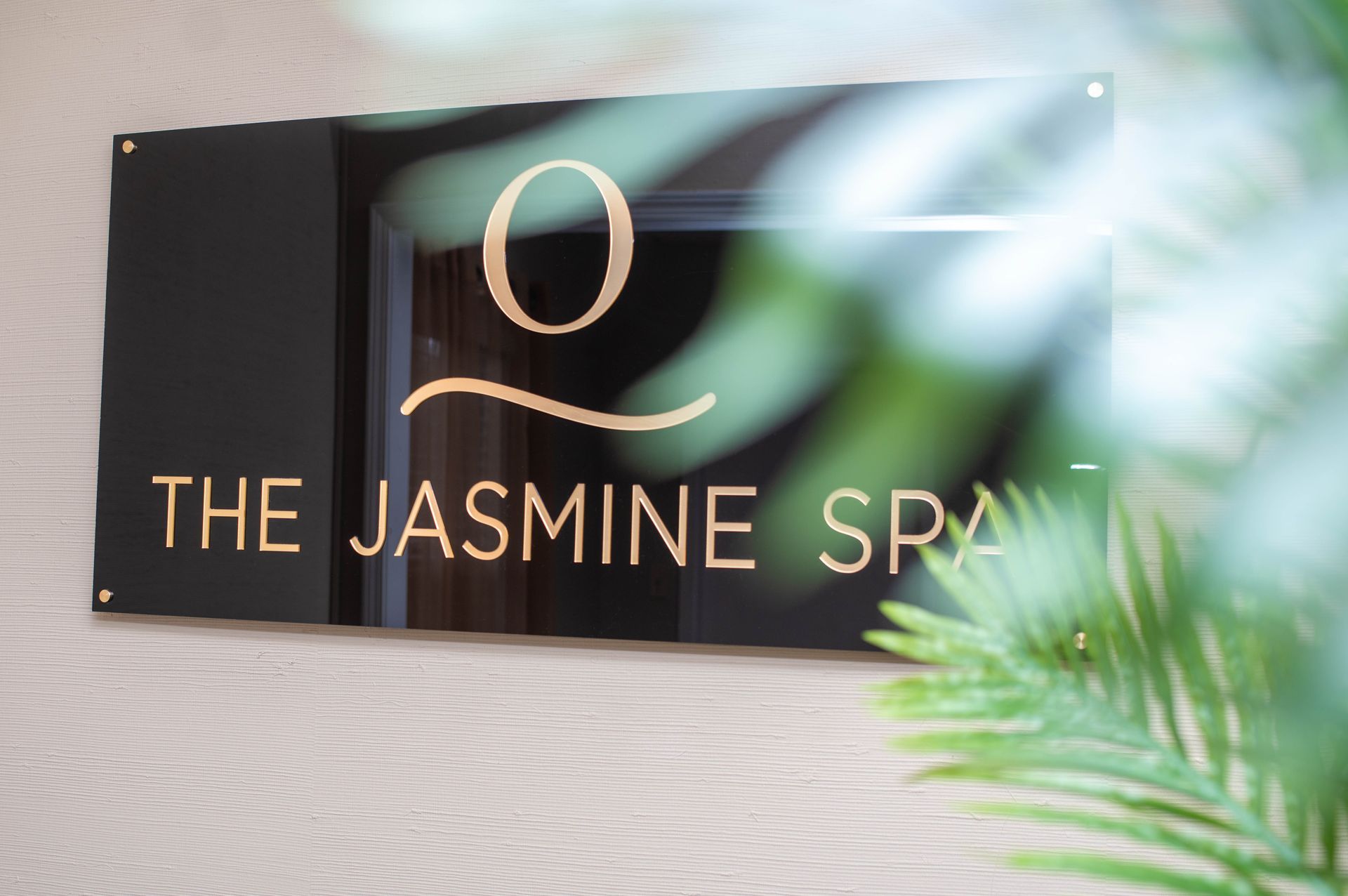 Black sign with gold lettering, 