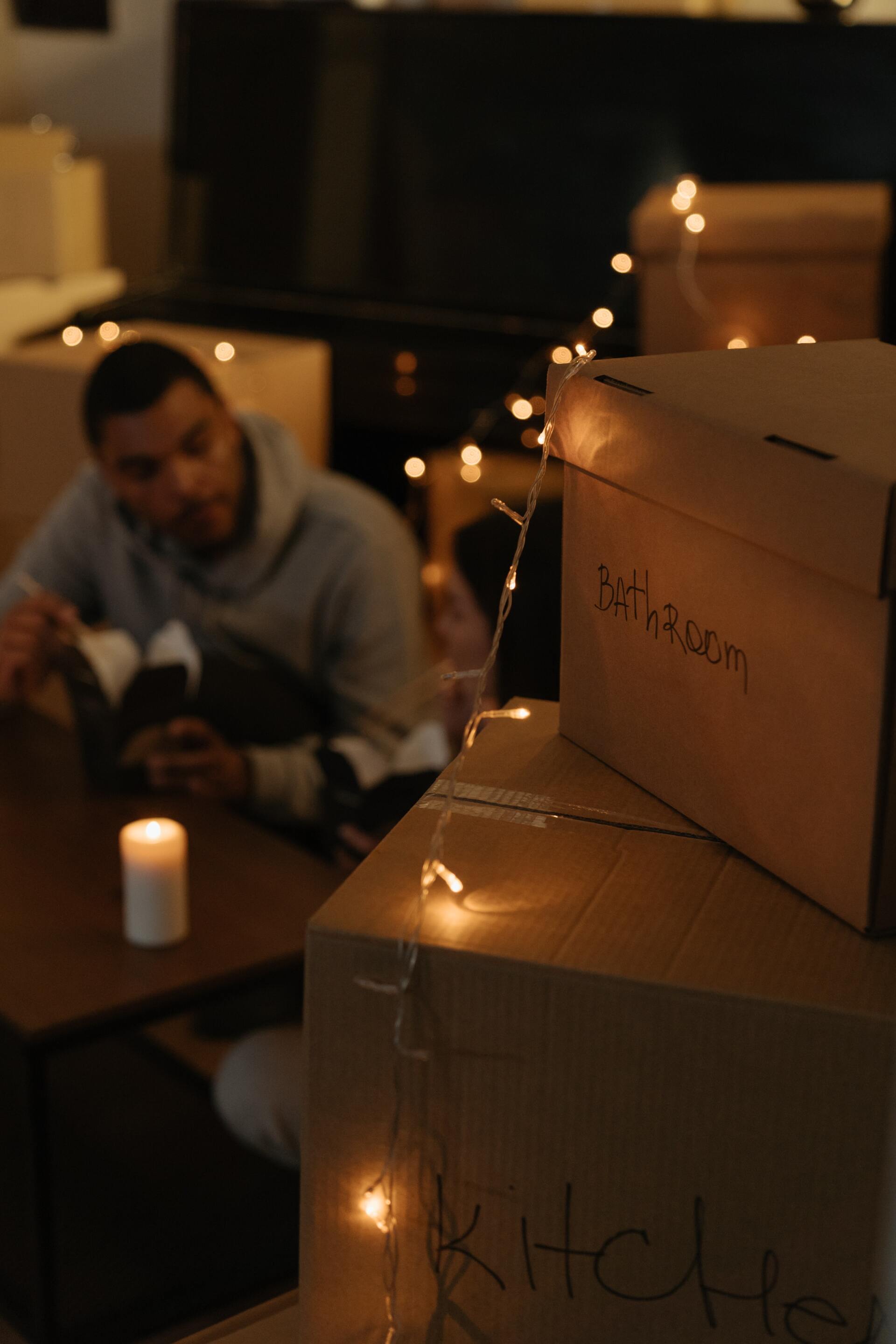 A family sitting together surrounded by moving boxes