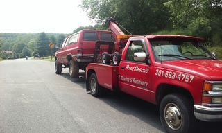 Car is Being Towed by Truck