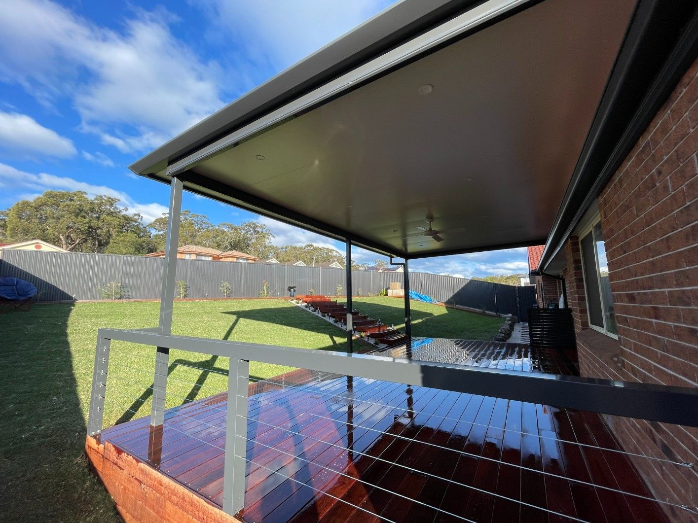 A Covered Patio Facing The Backyard