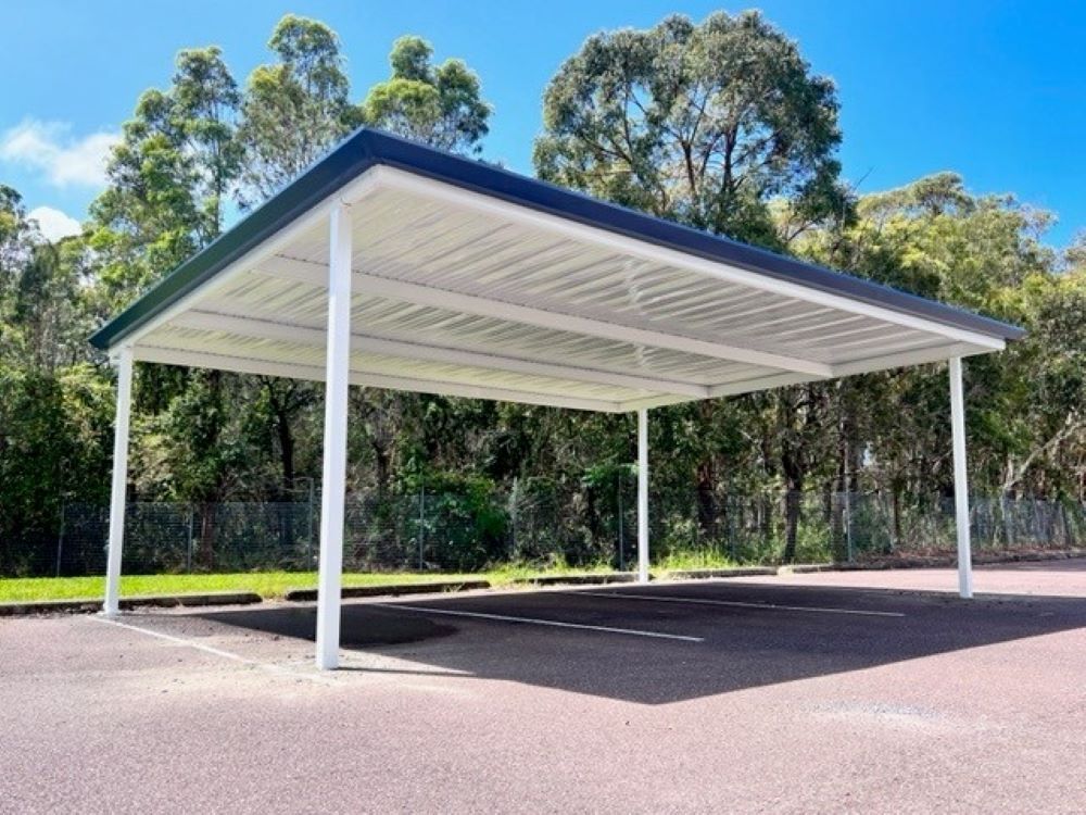 A Carport in a Parking Lot With Trees in the Background — Outdoor Leisure Living In Tuggerah, NSW