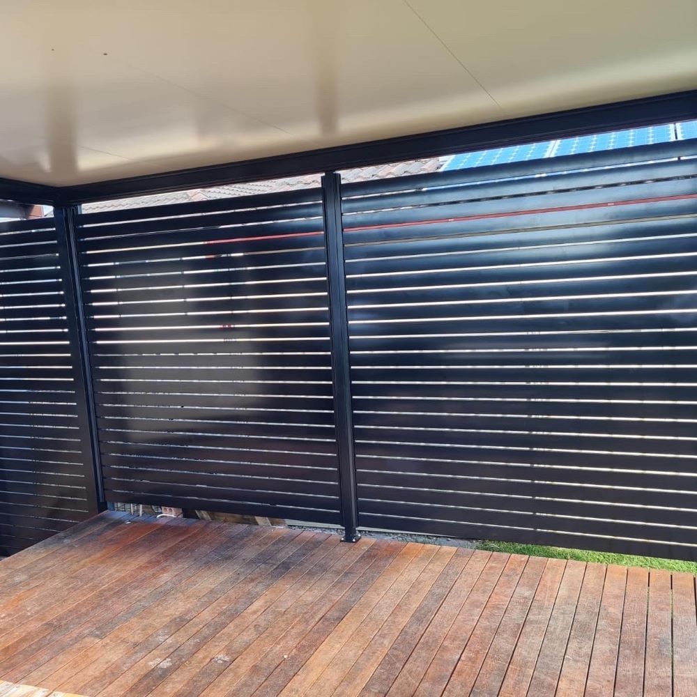 A Wooden Deck With a Black Fence Behind It — Outdoor Leisure Living In Tuggerah, NSW