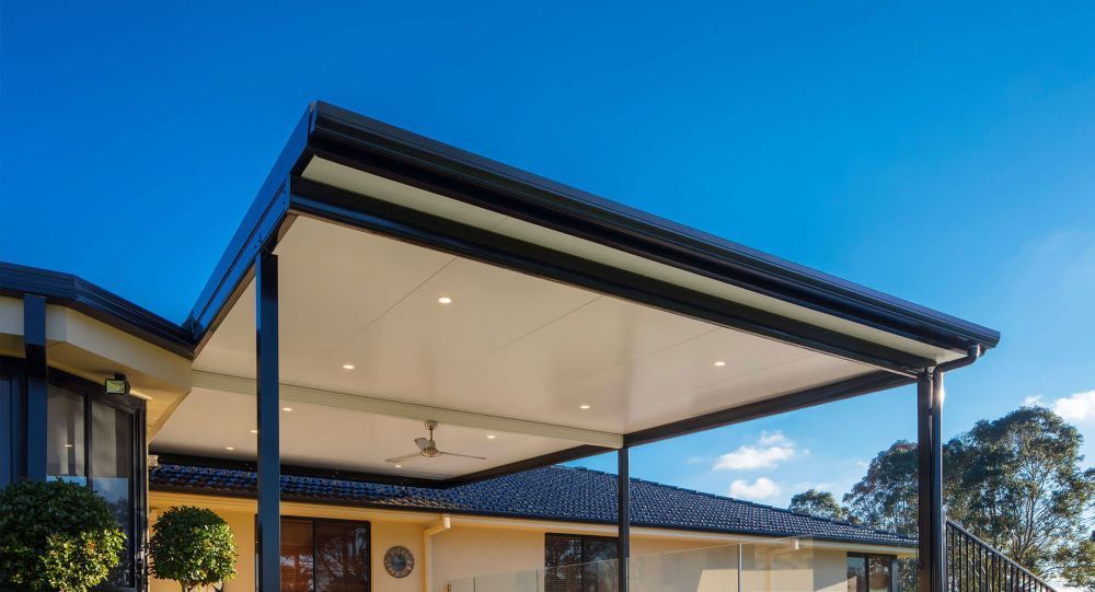 A House With a Covered Porch and a Blue Sky in the Background — Outdoor Leisure Living In Tuggerah, NSW