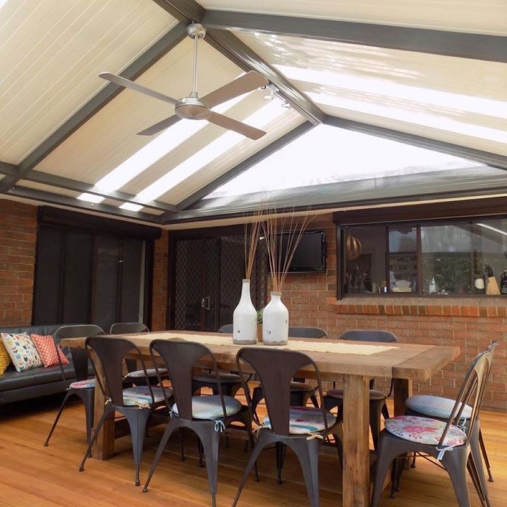 A Dining Room With a Table and Chairs and a Ceiling Fan — Outdoor Leisure Living In Tuggerah, NSW
