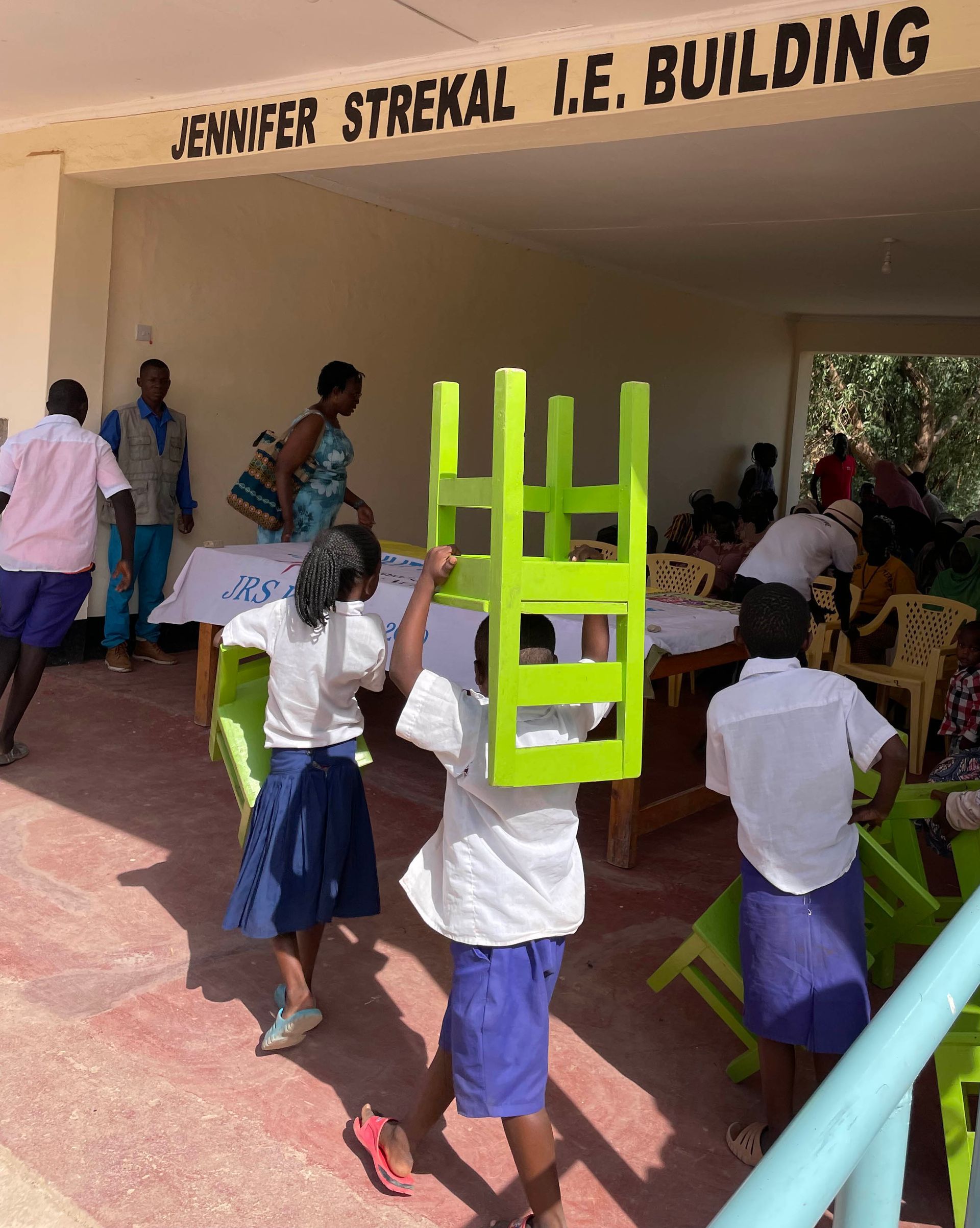 Kids carring chairs