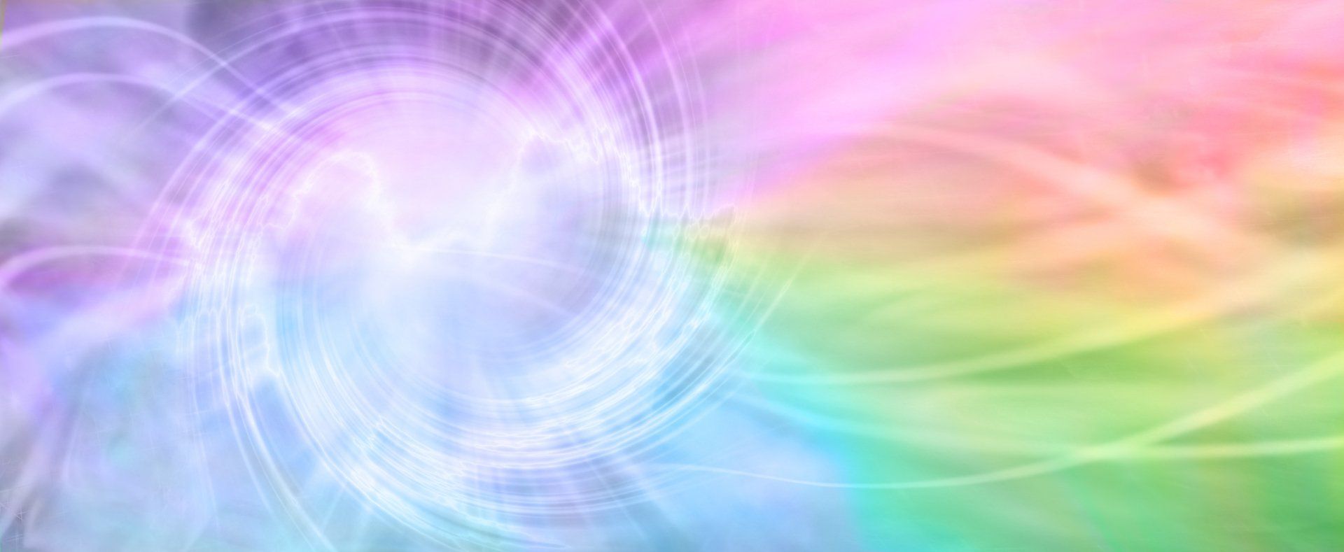 A rainbow colored background with a swirl in the middle