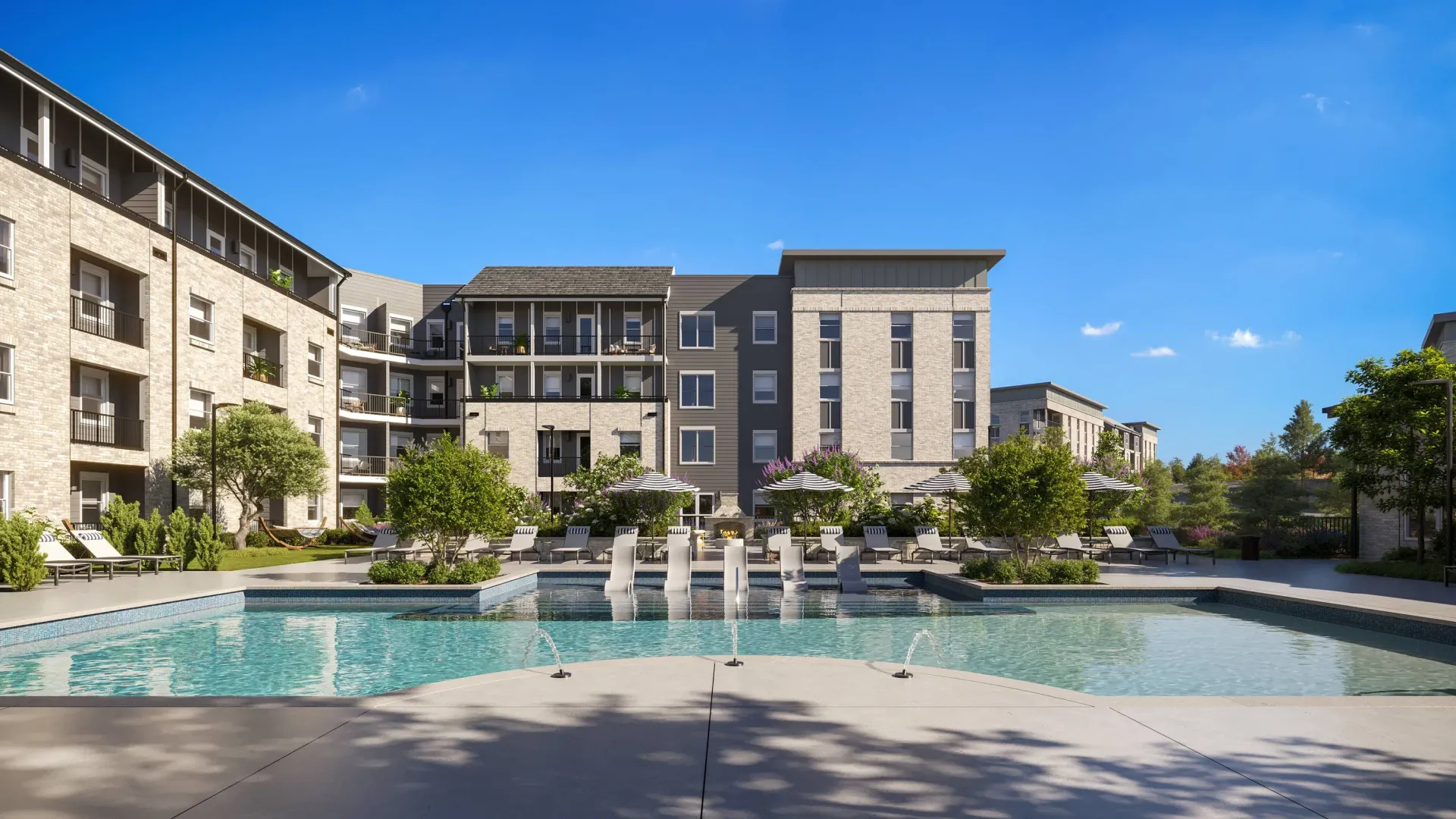 Community pool area featuring lounge chairs and greenery.