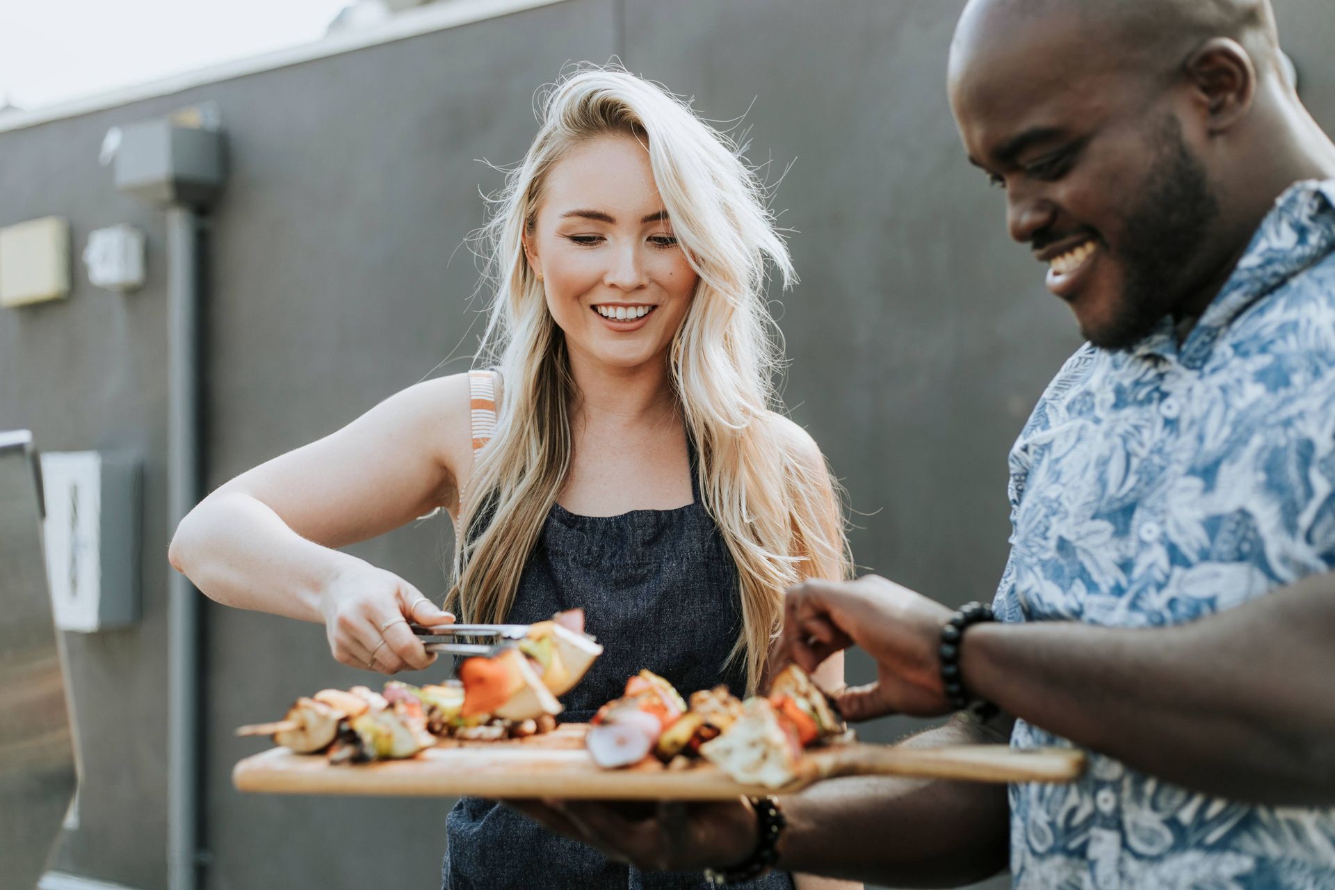 A modern office interior with people around a table, a lounge area, and a glass partition.