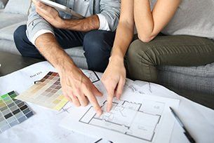 Couple looking over their new home construction plan of their new home in Kamloops