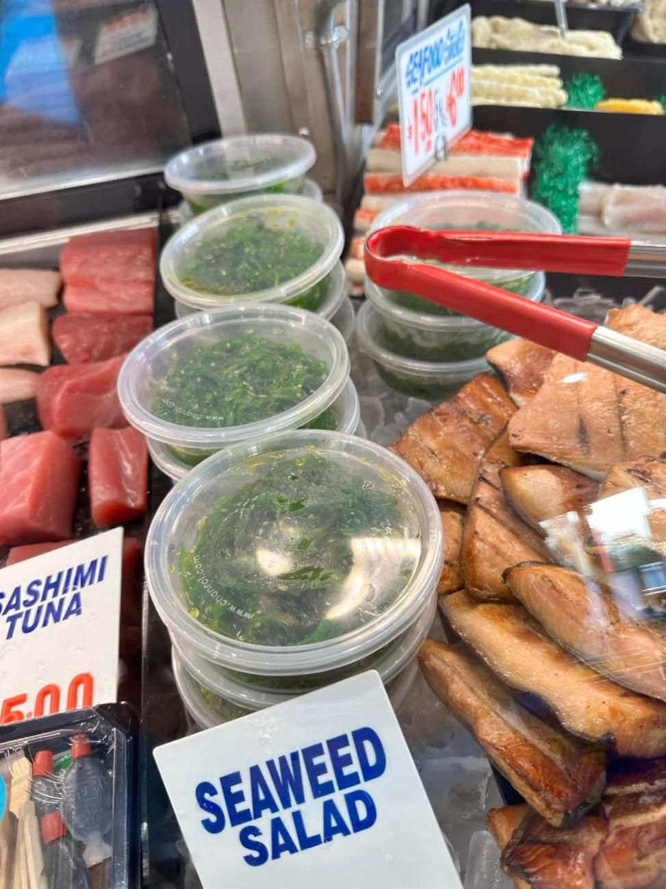 A Display Case Filled With Seaweed Salad And Tongs — Northern Rivers Seafood In Ballina, NSW