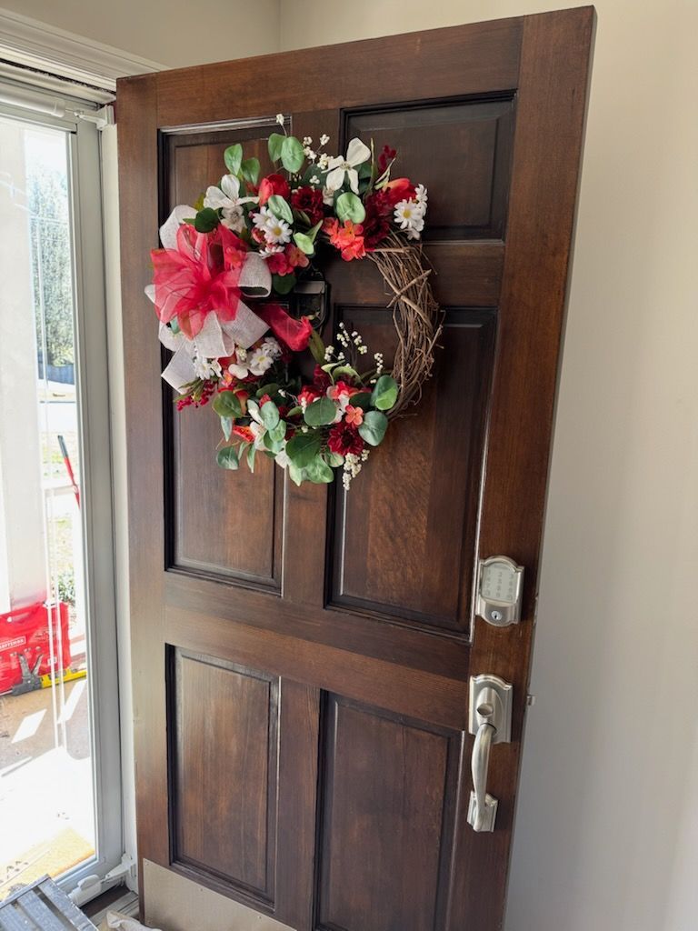 A kitchen with white cabinets , stainless steel appliances , and a large island.