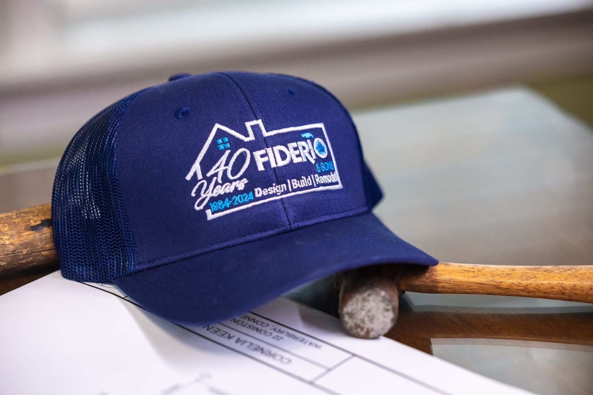 Blue baseball cap with company logo and text