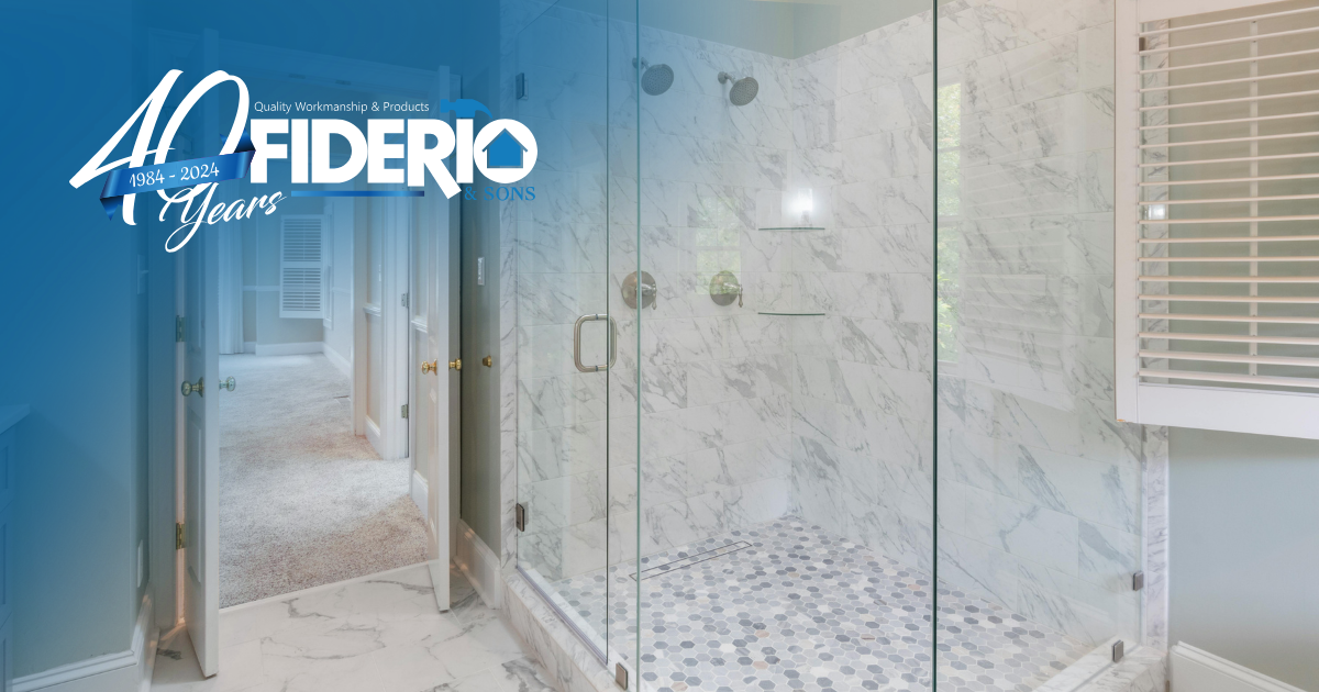 A modern walk-in shower with marble walls, a pebble floor, and glass doors, featuring a Fiderio company branding overlay.