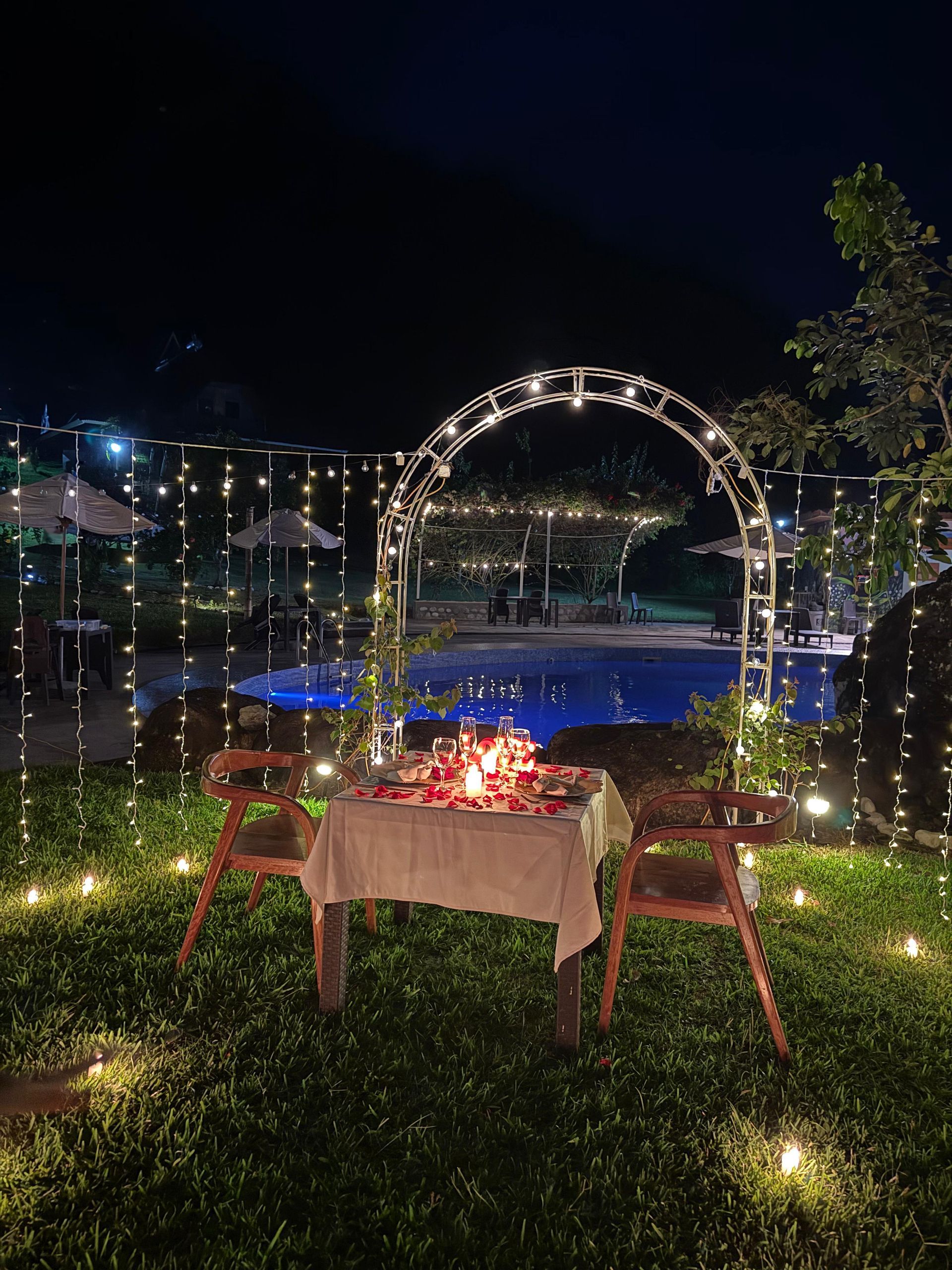A man is standing on top of a hill looking at the sunset.