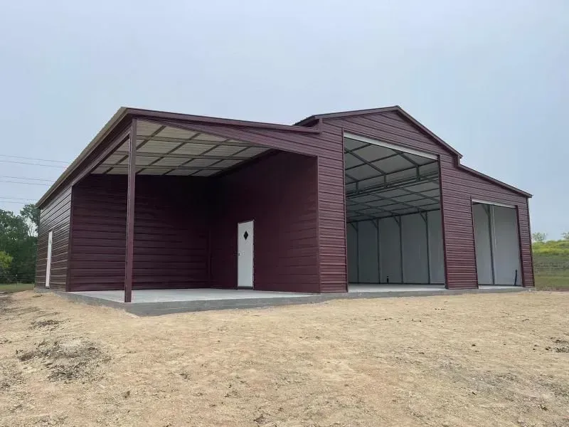 Mighty Comics storefront under a cloudy sky. Beige building with a sign. Open glass windows, door in the middle.
