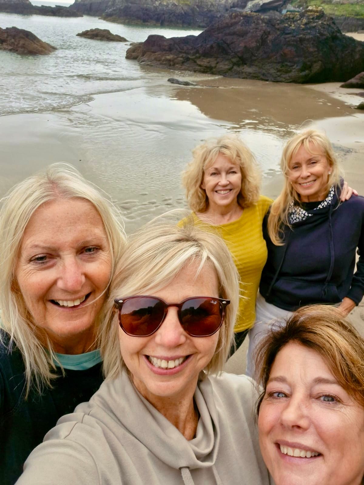 Group of friends walking the South West Coast Path towards Sharrow Beach near Whitsand Bay, Cornwall
