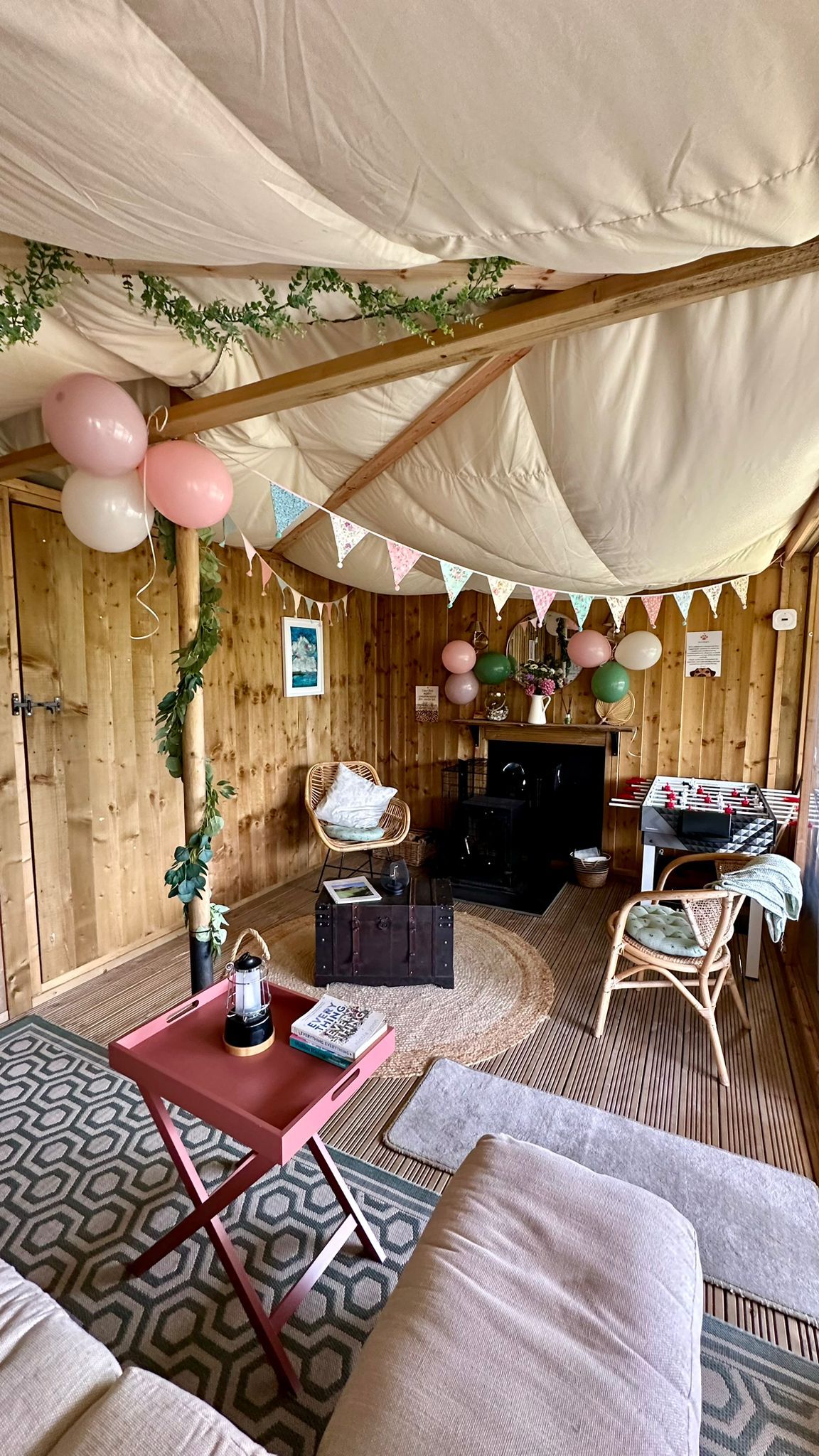 Cosy safari tent interior decorated for a birthday celebration with personal touches and soft coastal décor
