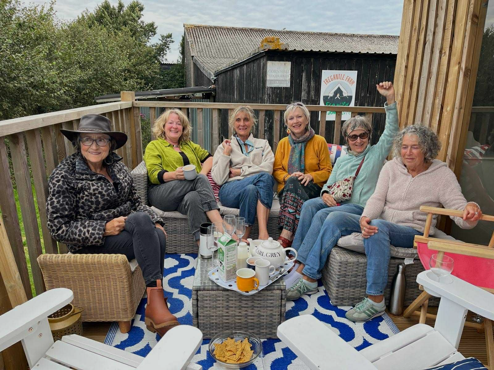 Friends enjoying morning tea together outdoors after a birthday celebration weekend at the eco glampsite
