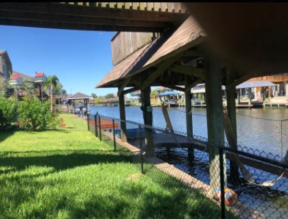 Aged wooden fence near new lumber boards.