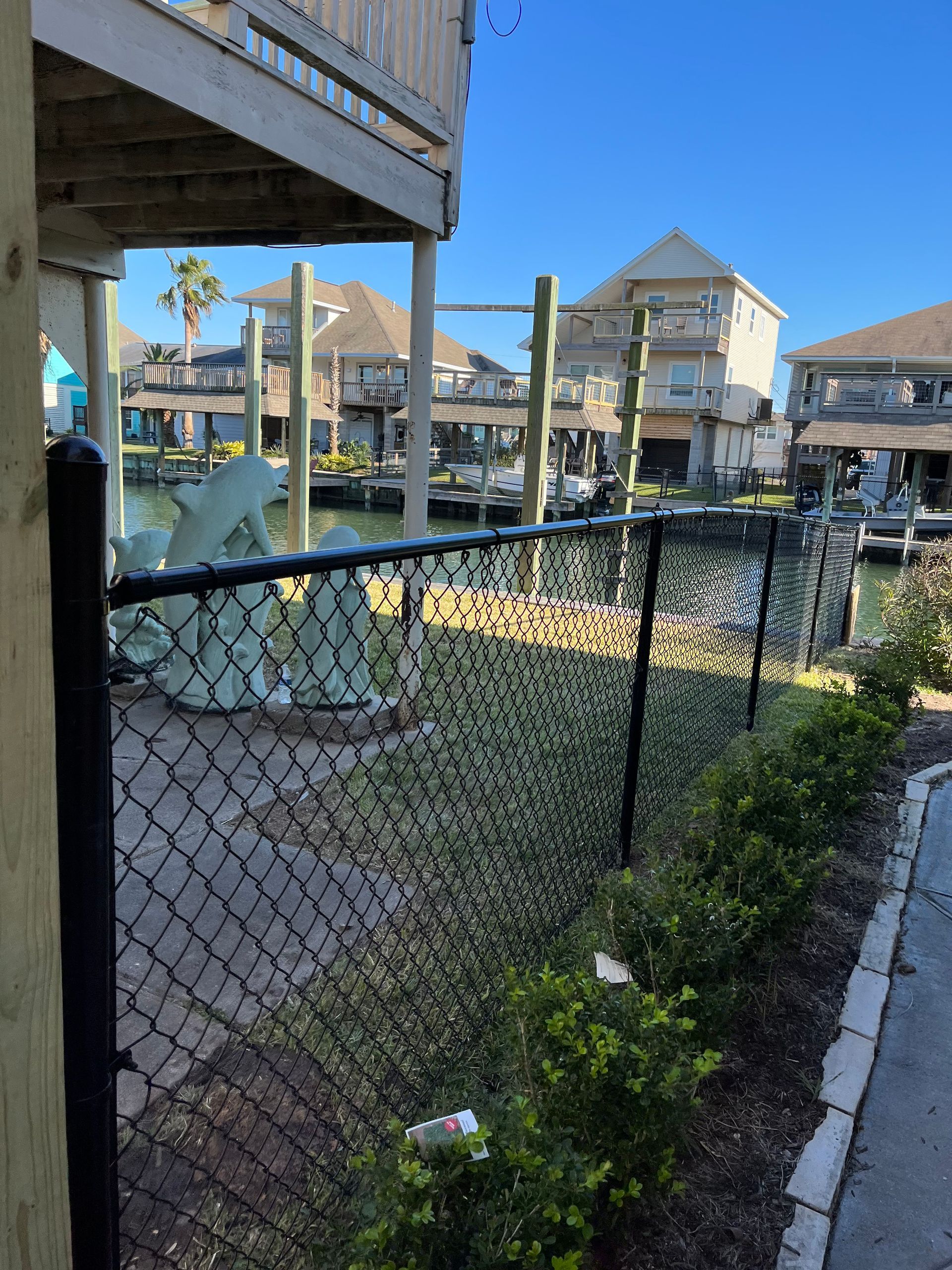 Aged wooden fence near new lumber boards.