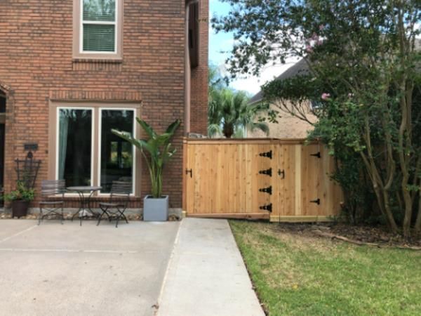 Aged wooden fence near new lumber boards.