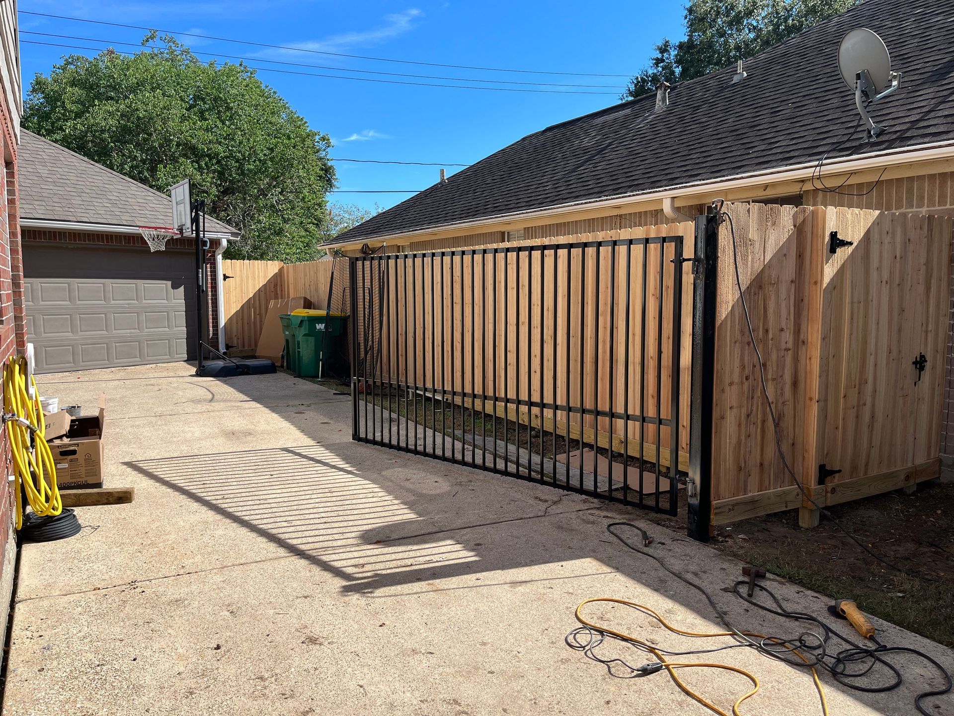 Aged wooden fence near new lumber boards.
