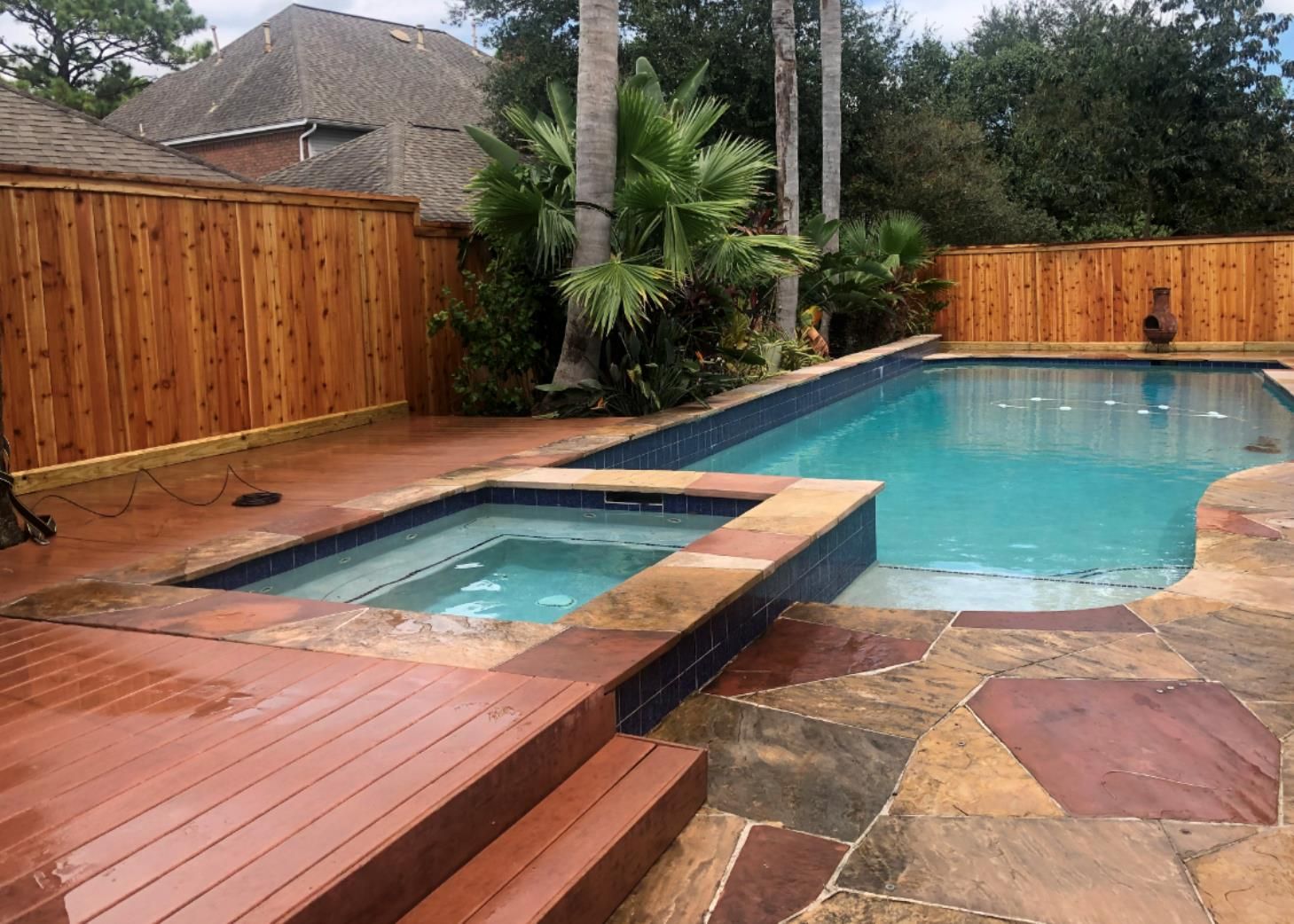 Aged wooden fence near new lumber boards.