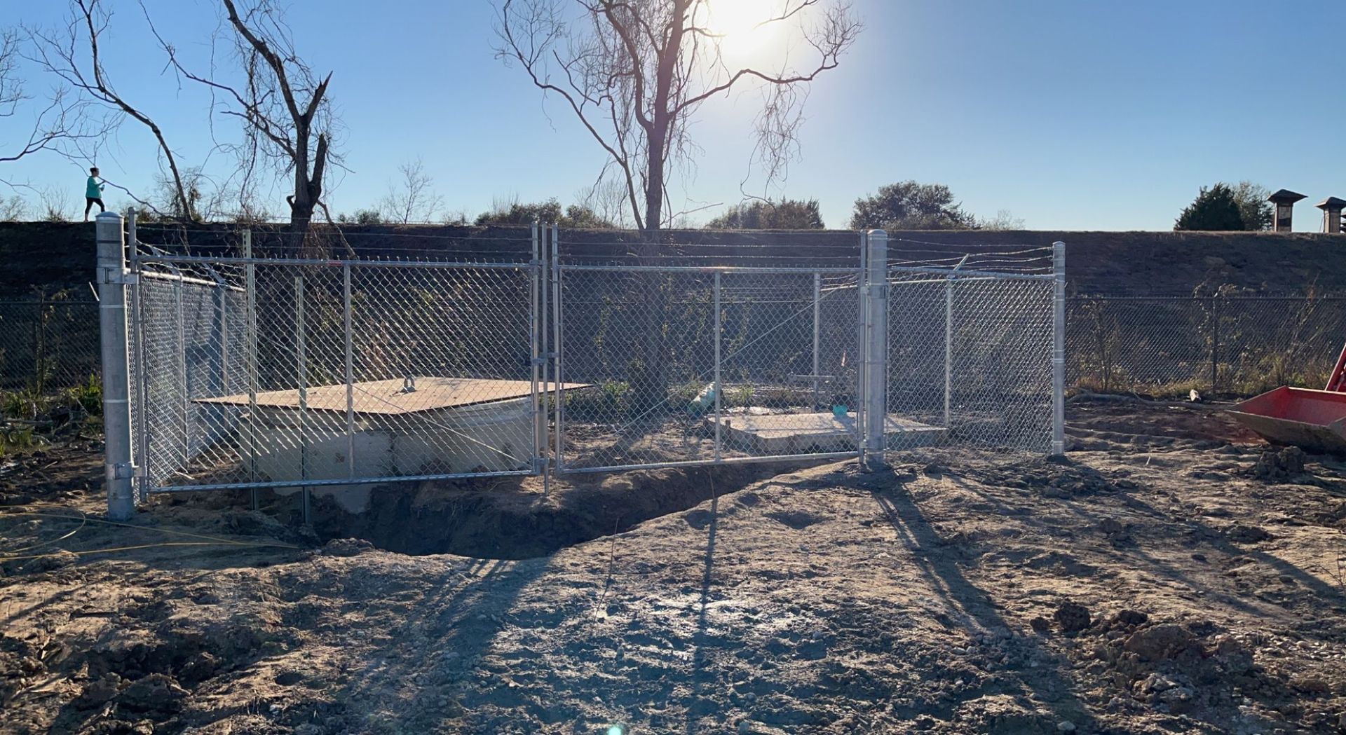 Aged wooden fence near new lumber boards.