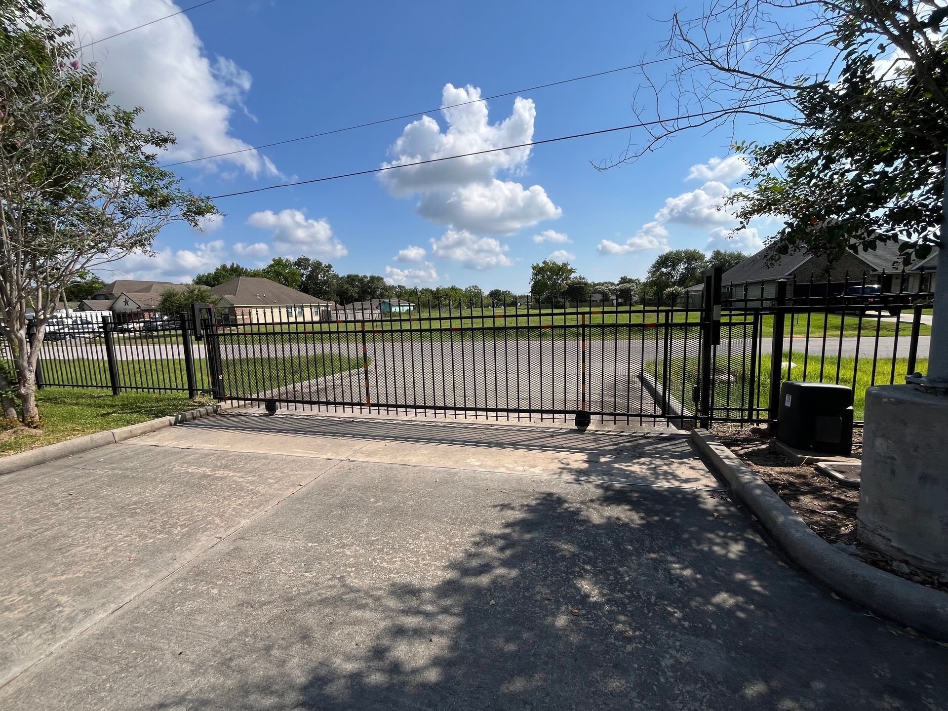 Stack of vertical slat replacement fence panels in a residential backyard, prepared for installation.