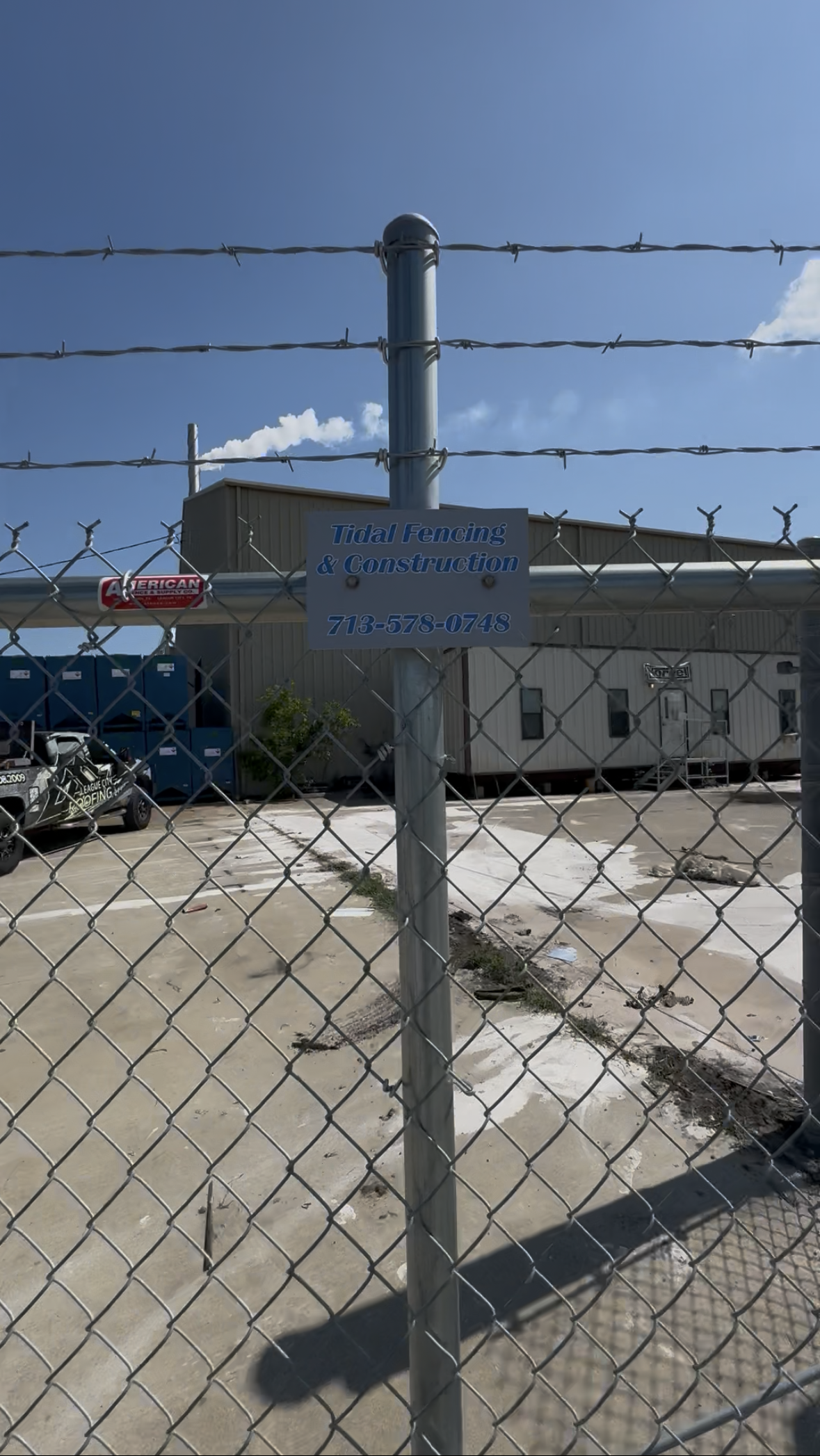 Aged wooden fence near new lumber boards.