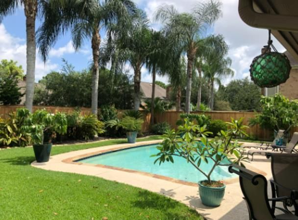 Aged wooden fence near new lumber boards.