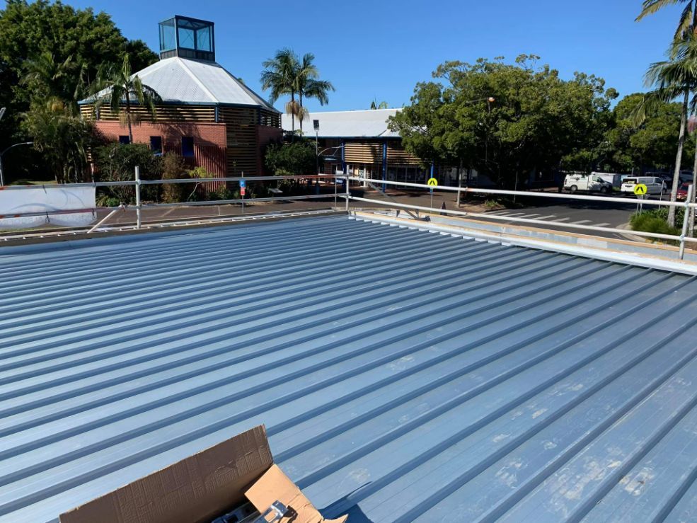 A Roof With a Box of Screws on It — Monty's Metal Roofing In Ocean Shores, NSW