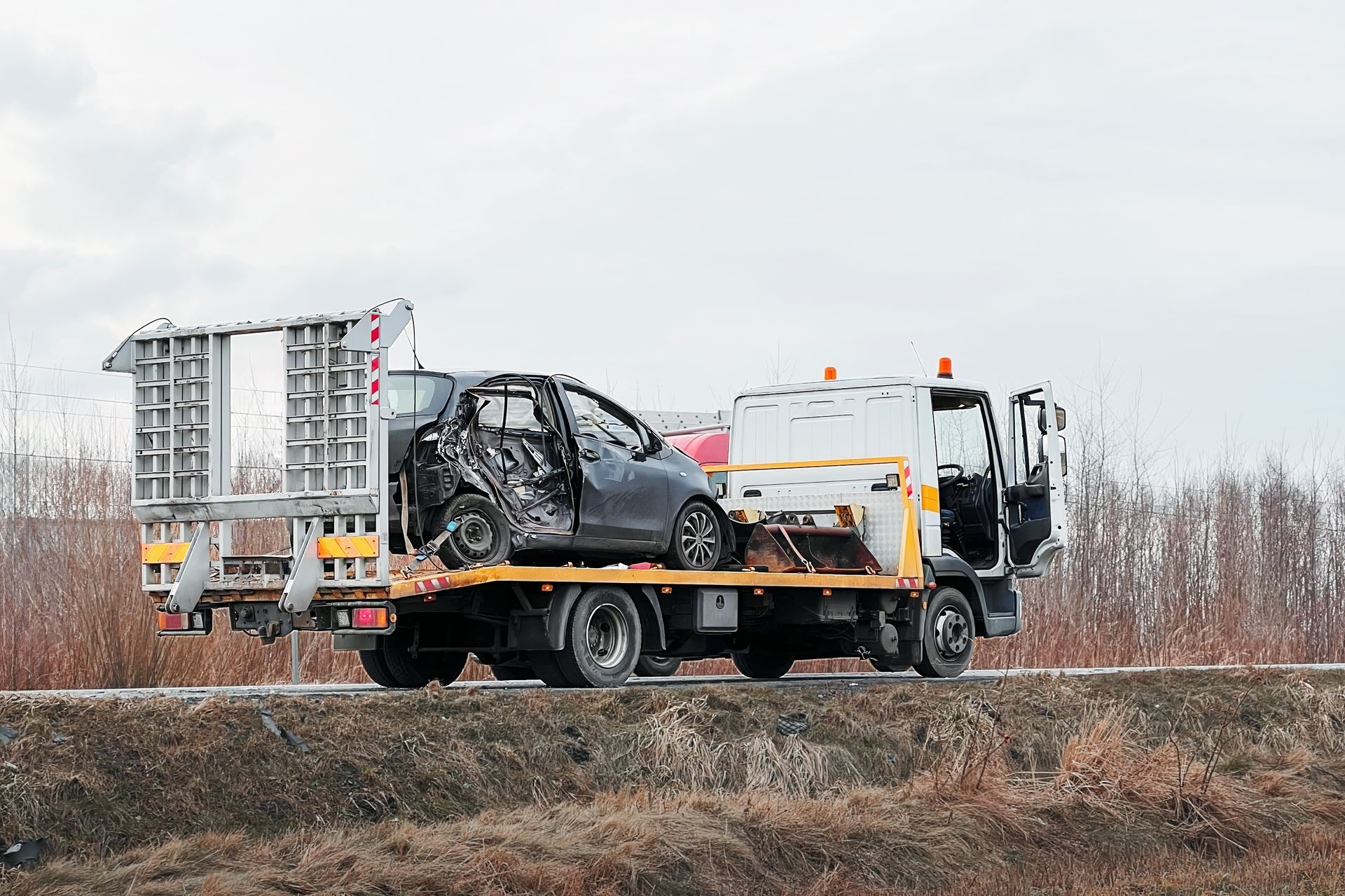 Family gathered at a dining table in a kitchen. They are eating and talking together.