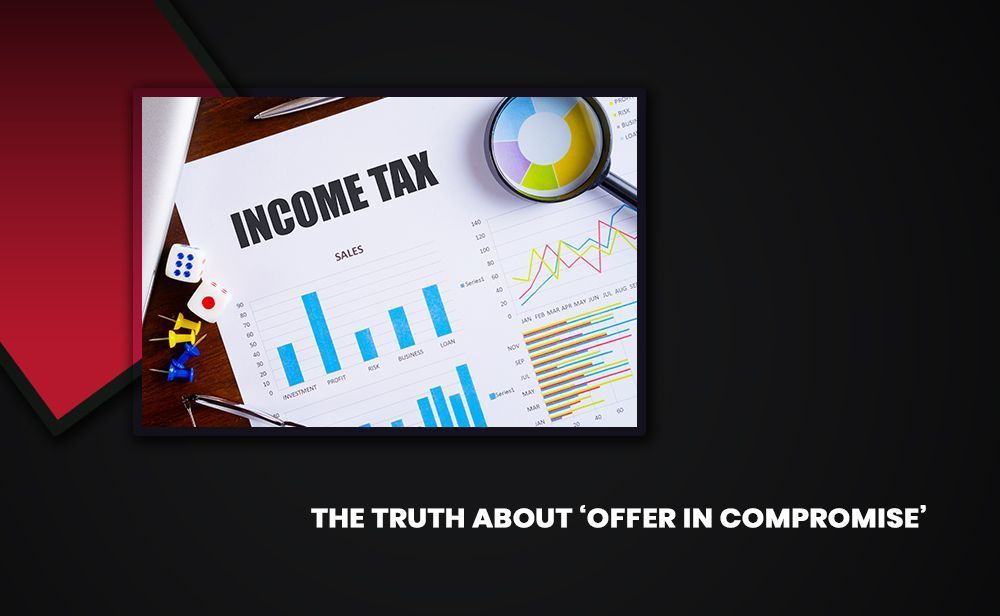 A magnifying glass is sitting on top of a piece of paper that says income tax.