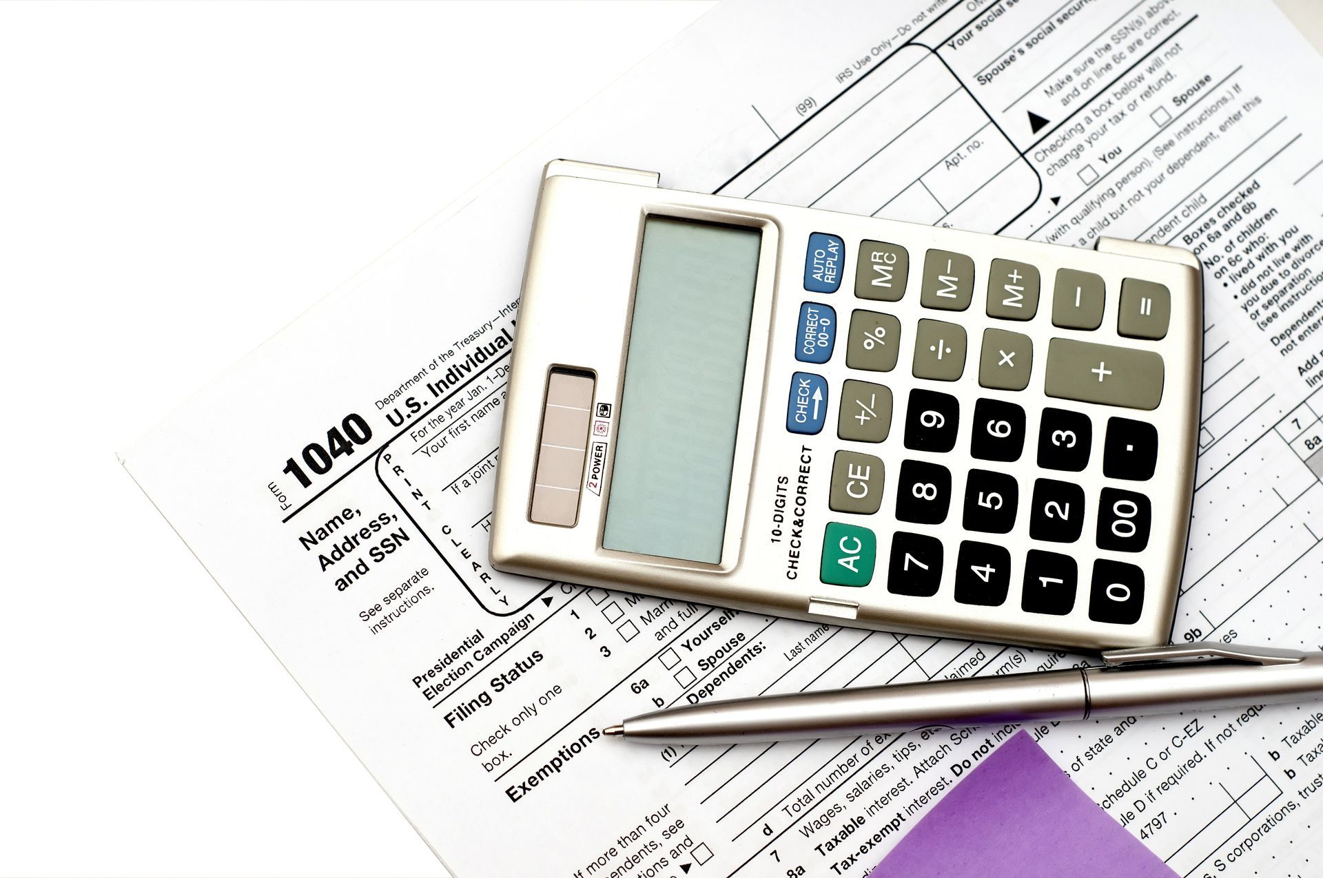 A calculator is sitting on top of a 1040 tax form