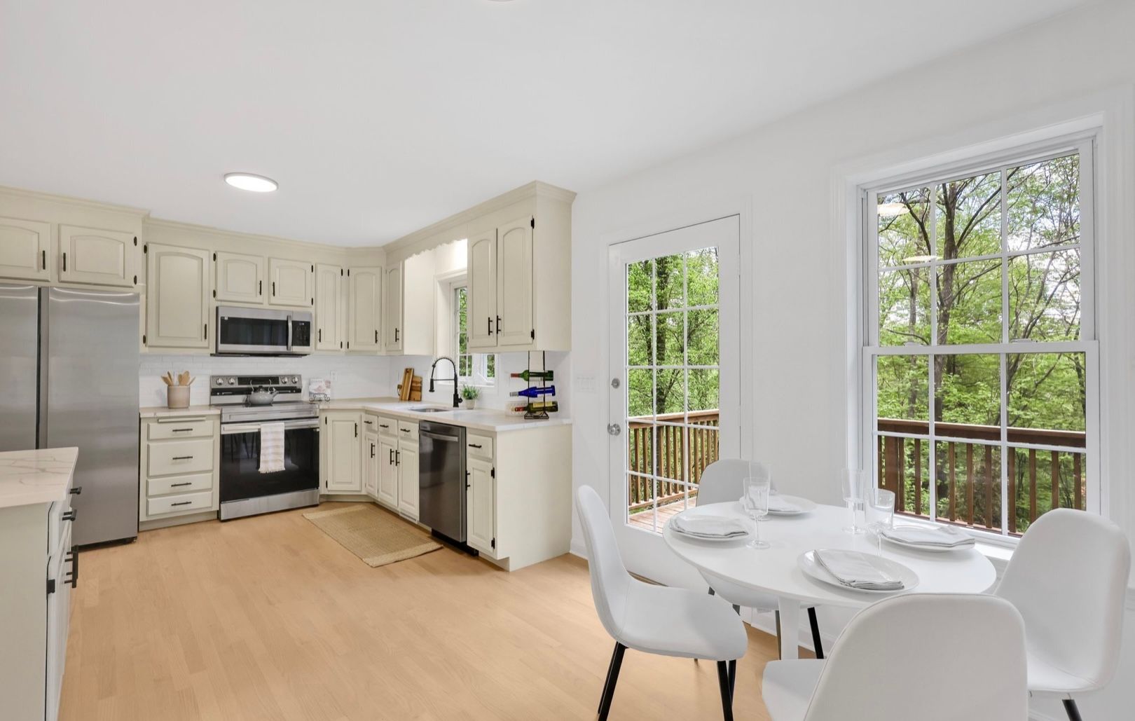 A vase of flowers is sitting on a table next to a window.