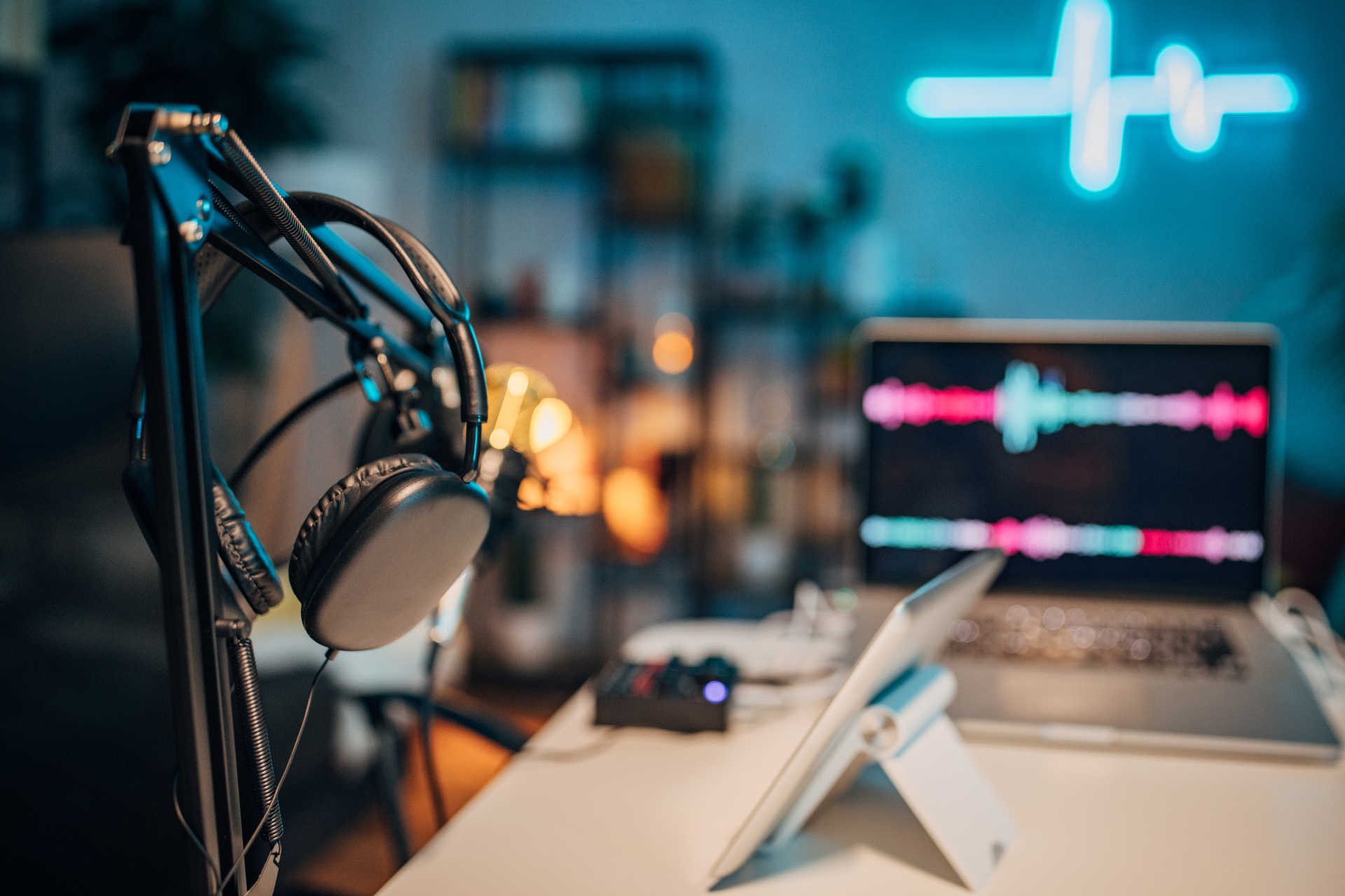 A microphone is sitting on a desk next to a laptop