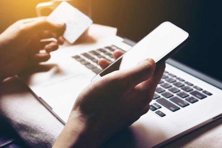Woman using smartphone and login internet banking for shopping online.