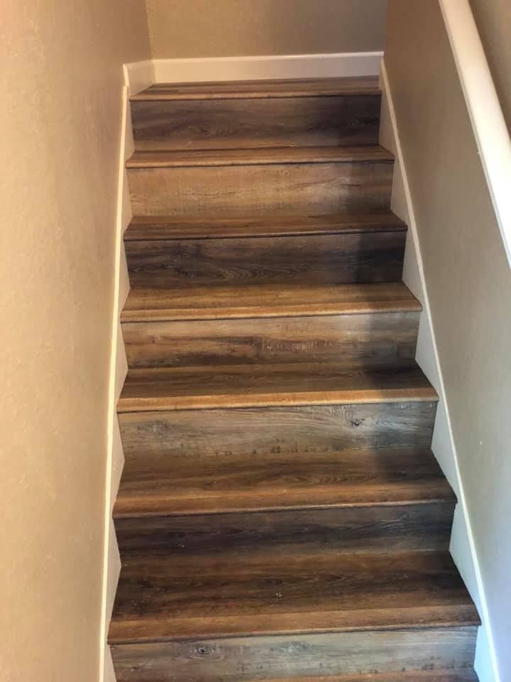 A set of wooden stairs leading up to the second floor of a house.