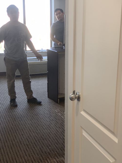 A man standing in a room with a door open