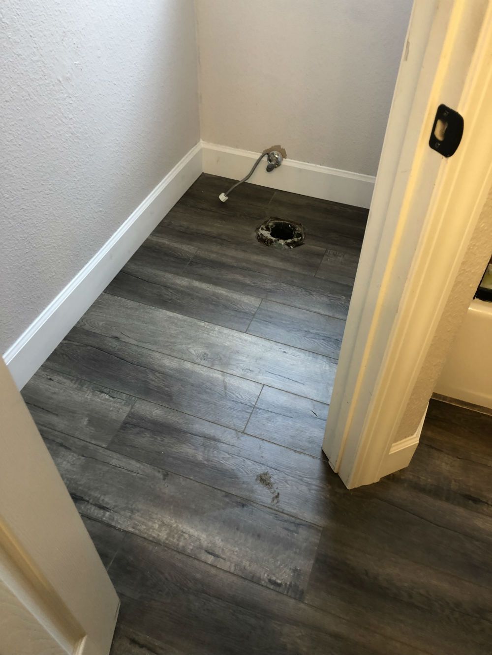 A bathroom with hardwood floors and a toilet.