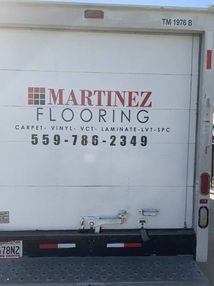The back of a white martinez flooring truck