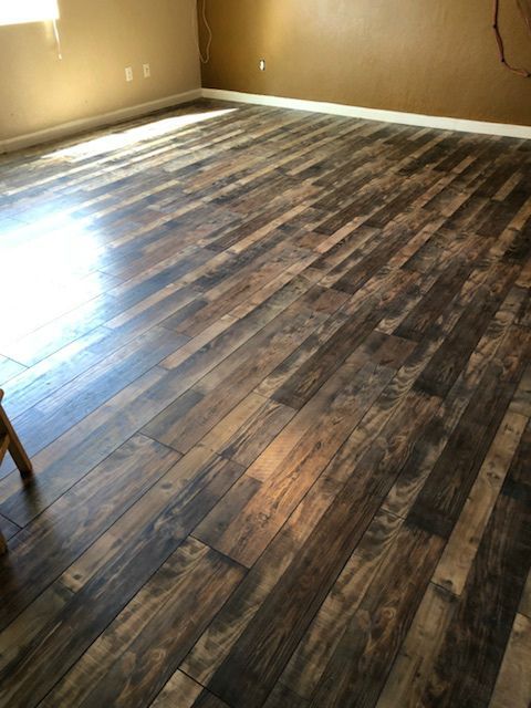 A room with a wooden floor and a chair in it.