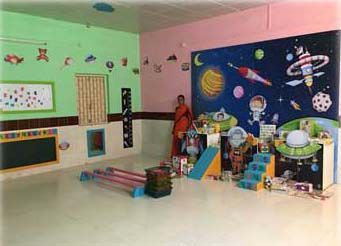 A woman is standing in a room with a mural on the wall.